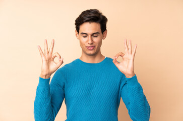 Naklejka premium Man over isolated background in zen pose