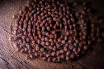 Still life with Walnut kernels and whole walnuts on rustic old wooden table. Creative table decoration.