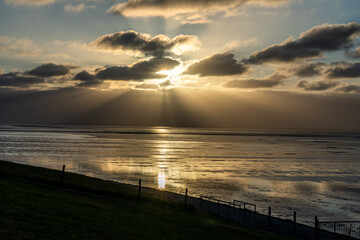 Obraz premium view on the wadden sea of the north sea at low tide at sunset near bernersiel