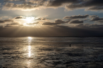 view on the wadden sea of the north sea at low tide at sunset near bernersiel