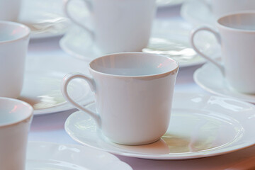 Obraz na płótnie Canvas Empty white coffee cups or tea cups in rows.