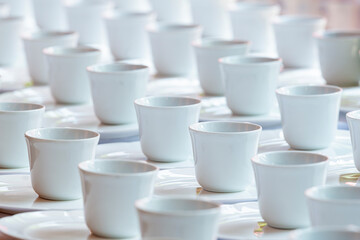 Group of empty coffee cups of white cup for service tea or coffee in breakfast and afternoon tea or buffet and seminar event of catering and cocktail. Selective focus.
