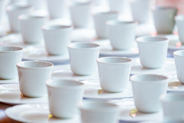 Obraz na płótnie Canvas Group of empty coffee cups of white cup for service tea or coffee in breakfast and afternoon tea or buffet and seminar event of catering and cocktail.
