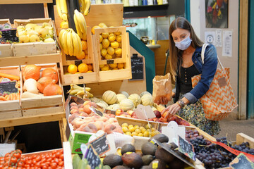 Woman at fresh food market wearing face mask