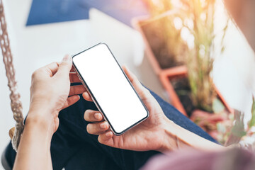cell phone mockup blank white screen.woman hand holding texting using mobile on desk at coffee shop.background empty space for advertise.work people contact marketing business,technology