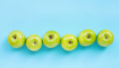 Green apples on blue background.