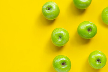 Green apples on yellow background.