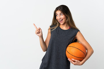 Young woman playing basketball isolated on white background pointing finger to the side and presenting a product