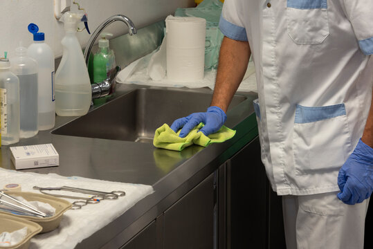Male cleaning staff perform cleaning and disinfection tasks in the hospital.