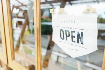 Welcome Open sign broad through the glass of window at coffee shop. shop ready to service, cafe...