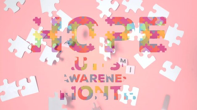 Hope and Autism Awareness Month text over jigsaw puzzle