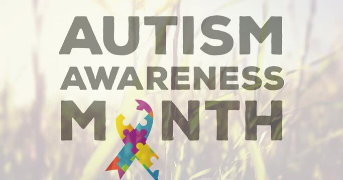 Autism Awareness Month text against tall grass moving in the wind