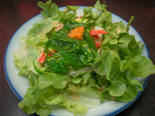 Fresh vegetable Salad with Japanese seaweed and shrimp eggs. Healthy organic food.