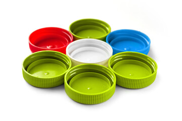 Colored PET lids. Recycled plastic bottle caps isolated on white background. Separate garbage collection. Recycling of plastic for prosthetics.