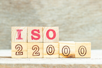 Alphabet letter in word iso 22000 on wood background