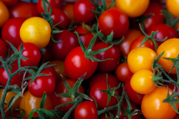 Red and yellow cherry tomatoes top view. Harvest vegetables. Tomato on the table. Vitamin healthy food. Rustic kitchen