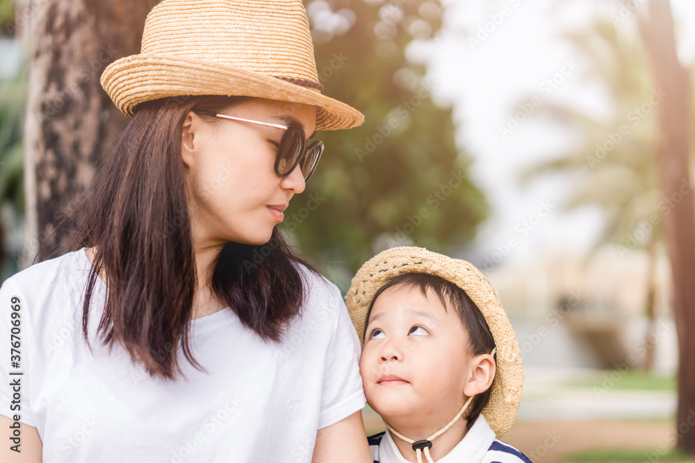 Wall mural Happy loving family.Asian mother and baby boy child talking in playground outdoor at the park.Cute child with mother encourage and play.Child development,Mother and son traveller, Healthcare, People.