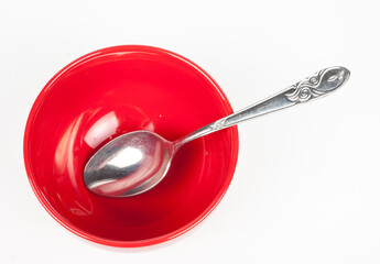 Red plate with spoon on white