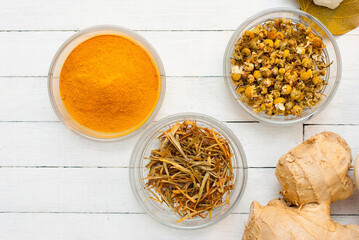 Spices and herbs on white wood table
