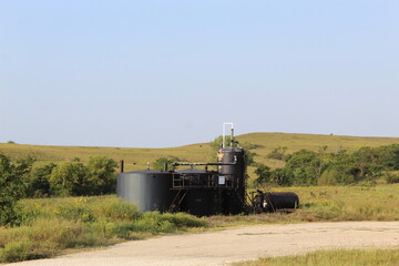 Fototapeta premium Oil storage tanks located on Kansas prairie