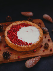 Autumn lingonberry homemade pie, on a dark background.