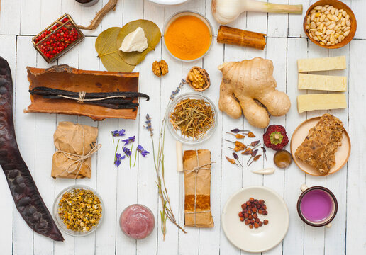 Spices and herbs on white wood table