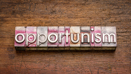opportunism, the practice of taking advantage of circumstances, word abstract in gritty vintage letterpress metal type stained by printing ink against rustic wood