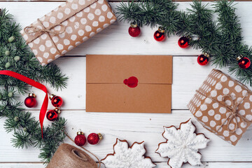White wooden background with coniferous branches and Christmas decorations