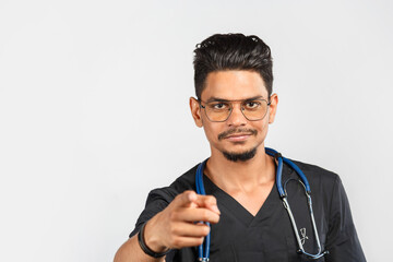 Indian doctor or surgeon with stethoscope in black uniform on gray background.