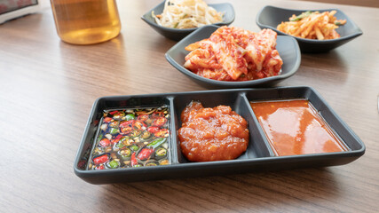 closeup set of sauce with side dishes on background