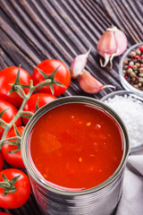 juicy canned tomatoes on wooden rustic background