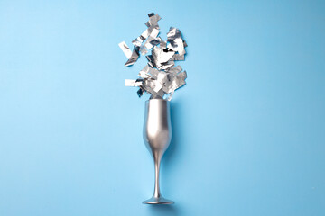 Champagne glass with confetti flat lay top view