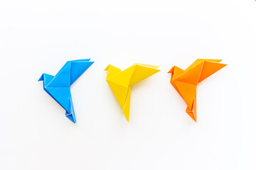 Paper birds of different shades. Origami concept. Top view