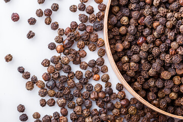 fragrant black pepper on white acrylic background