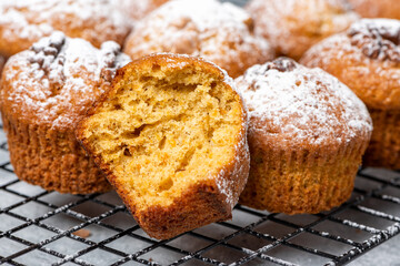 Freshly baked pumpkin muffins and walnuts, cinnamon and nutmeg. Autumn or winter food. Sweet seasonal pumpkin baked goods.