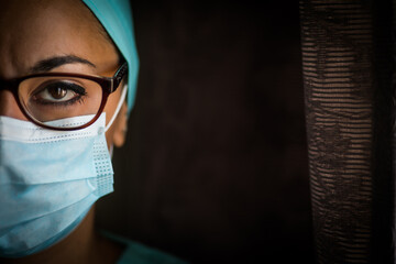 Young female medic, wearing a mask and glasses