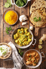 assortment of indian dish- naan, curry chicken, rice, tikka masala