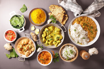 assortment of indian dish- naan, curry chicken, rice, tikka masala
