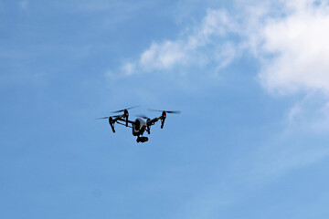 Drone flying in a blue sky