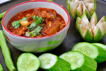 Nam Prik Ong is a local dish of northern Thailand, with its staple tomatoes, chili and minced pork served with fresh local vegetables such as cucumber, brinjal, and yard long beans.