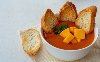 Pumpkin soup cream with crackers on a white table. The concept of healthy eating. Diet.