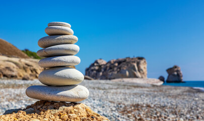 Fototapeta na wymiar Stack of stones on Aphrodite beach, Cyprus