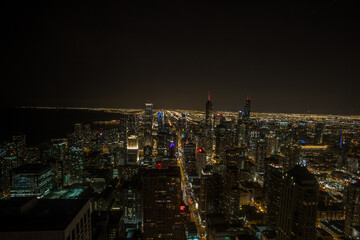 Fototapeta na wymiar Looking out over the Chicago landscape at night with lights