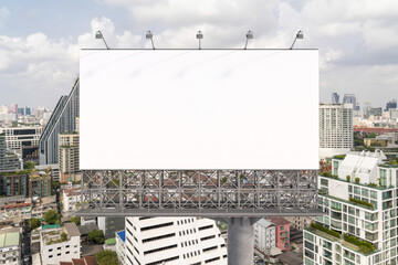 Obraz premium Blank white road billboard with Bangkok cityscape background at day time. Street advertising poster, mock up, 3D rendering. Front view. The concept of marketing communication to promote or sell idea.
