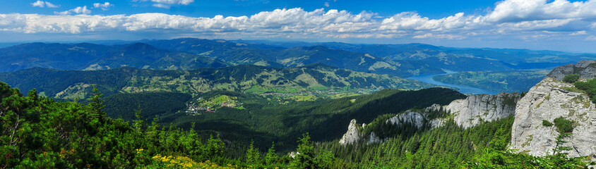 Fototapeta na wymiar Durau village and Bicaz Lake Panorama. View from Ceahlau Mountain, Carpathian Mountains, Romania