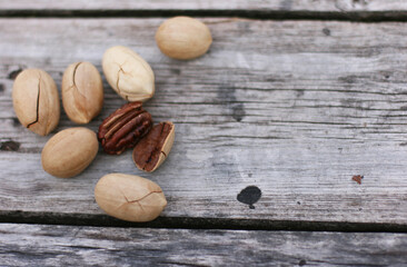 Pecan Nuts on wooden background, top view with copyspace. Close up veiw of nuts.
