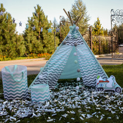 children's tent or wigwam with a dream catcher. Wigwam in park / garden. A lot of balloons blue and white color. Wigwam for recreation for children. The concept of lifestyle and decor. © Vladibulgakov