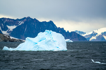 Antarctica, Antarctic Peninsula, cruising in the Lemaire Channel. Ice covered mountain and ice floes.  2020 