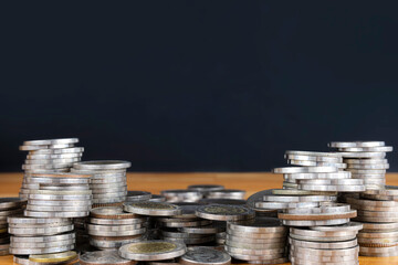 Concepts of financial business investment. A pile of coins stacked in numbers, the back area is...
