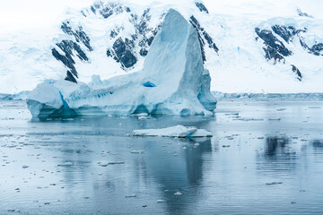 Antarctica, Antarctic Peninsula Area, Mountain and amazing Iceberg surrounded by ice floes....